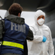 A Turkish military flight crew member, right, bumps elbows with a FEMA worker as crews unload a donation of medical supplies from Turkey in April.